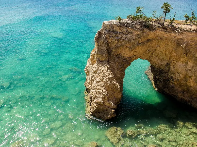 Limestone arch and turquoise water on Anguilla's coastline